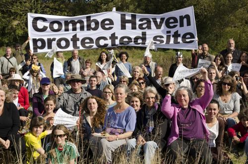 Campers at Combe Haven Defenders hold up a banner.